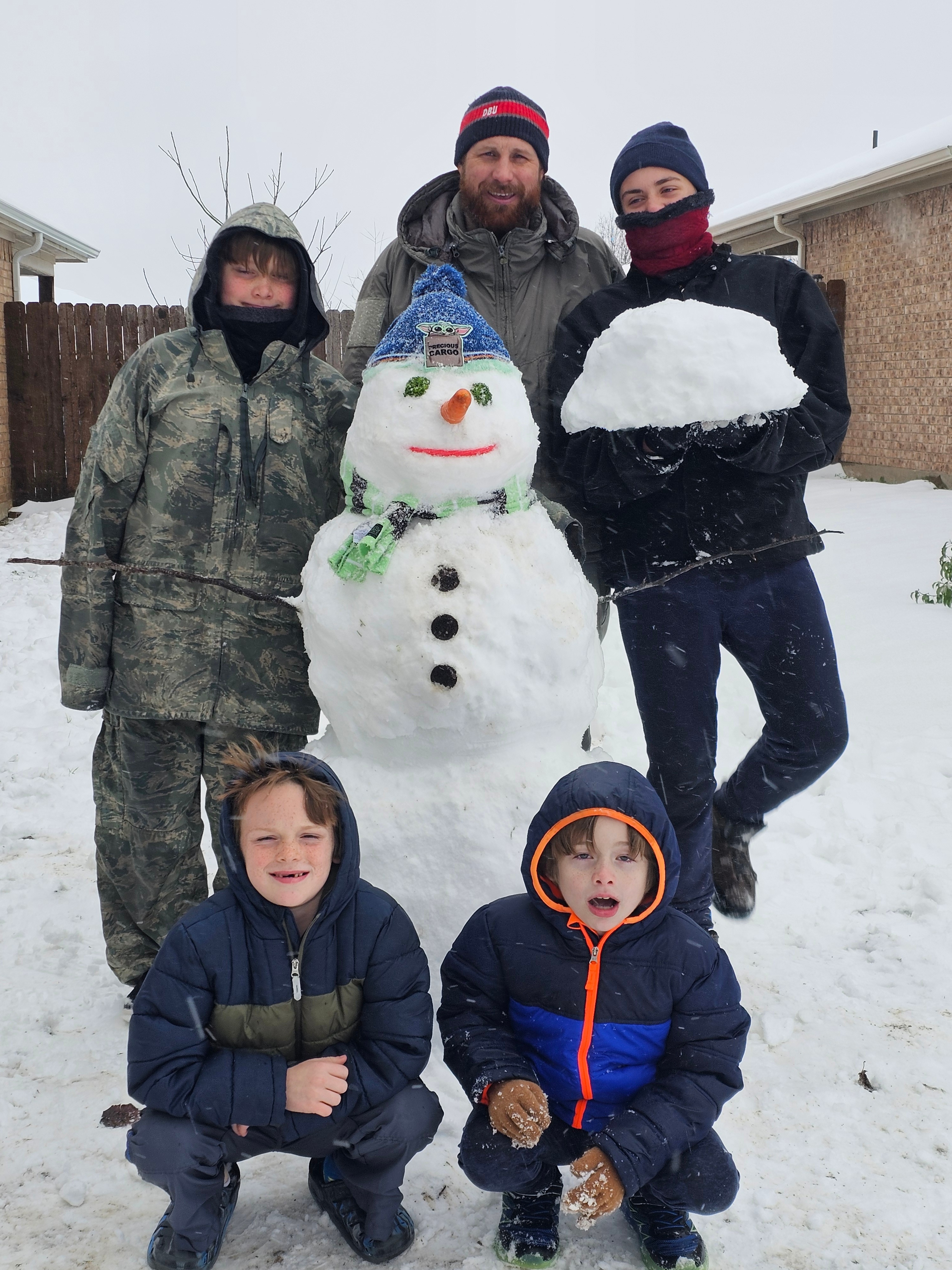 7 year old twins, 11 year old and 12 year old worked with dad to complete a snowman on this January snow day!