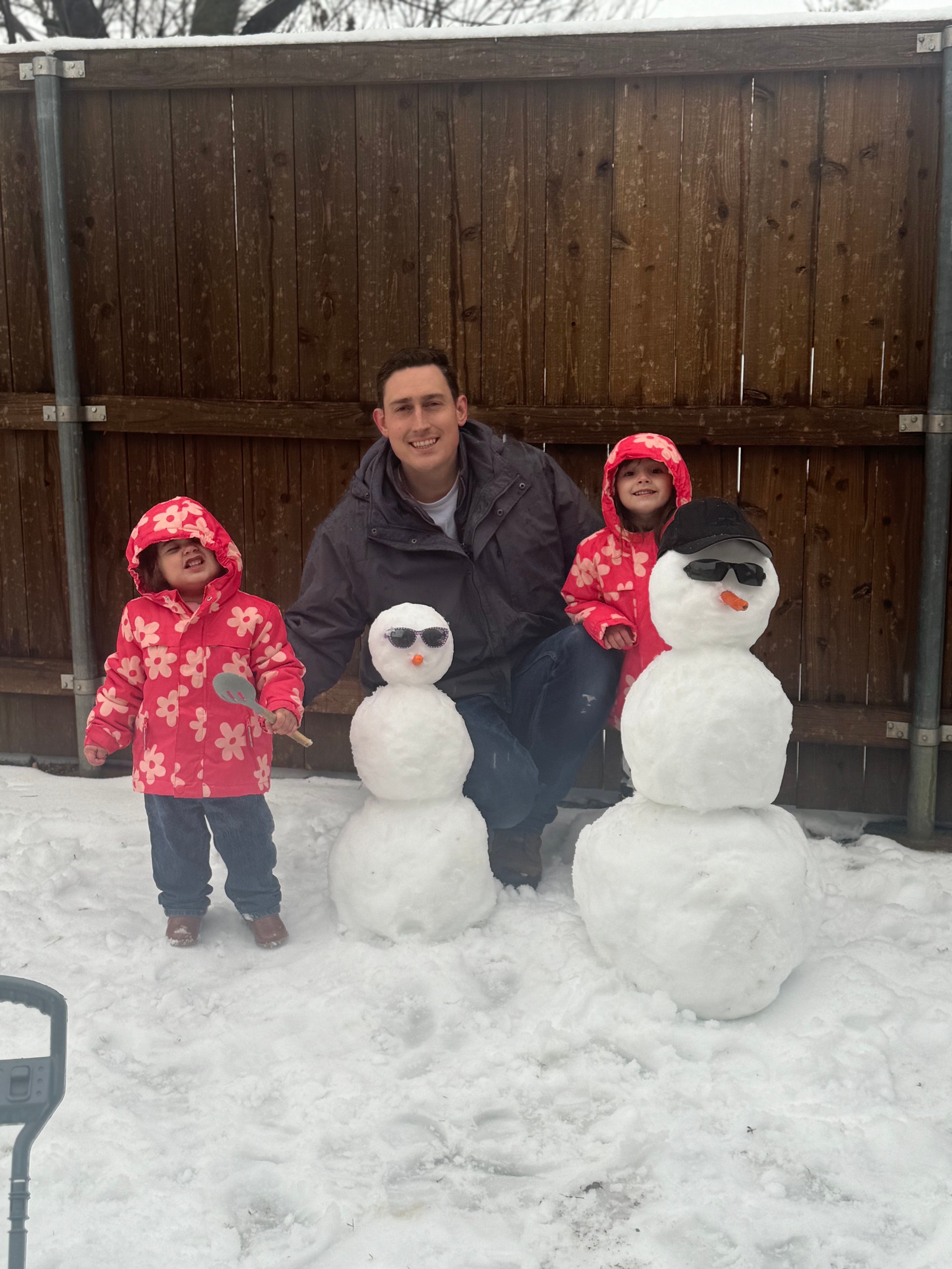 Mercy and Grace building their first snowmen with daddy in little elm!