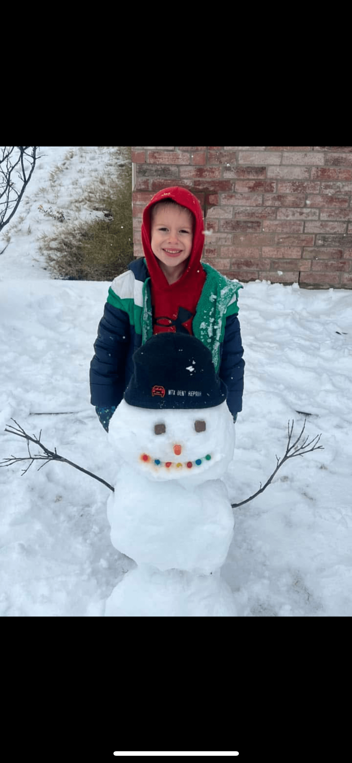 Jude Preston with snowman in Denton Tx