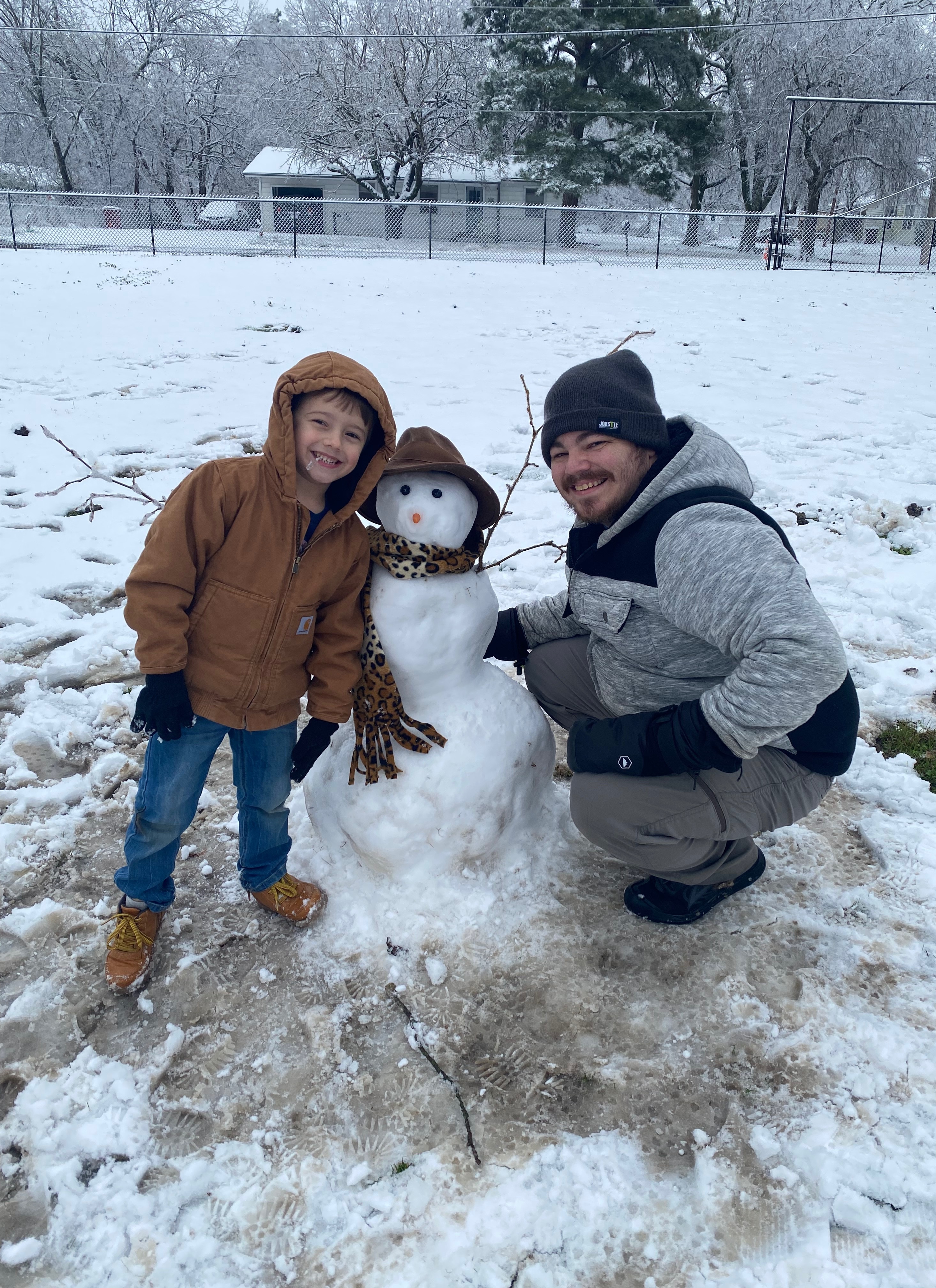 My son Jensen is five and this has been his first opportunity to build a snowman. He couldn’t have done it without his daddy, and as you can see, they’re both very proud!