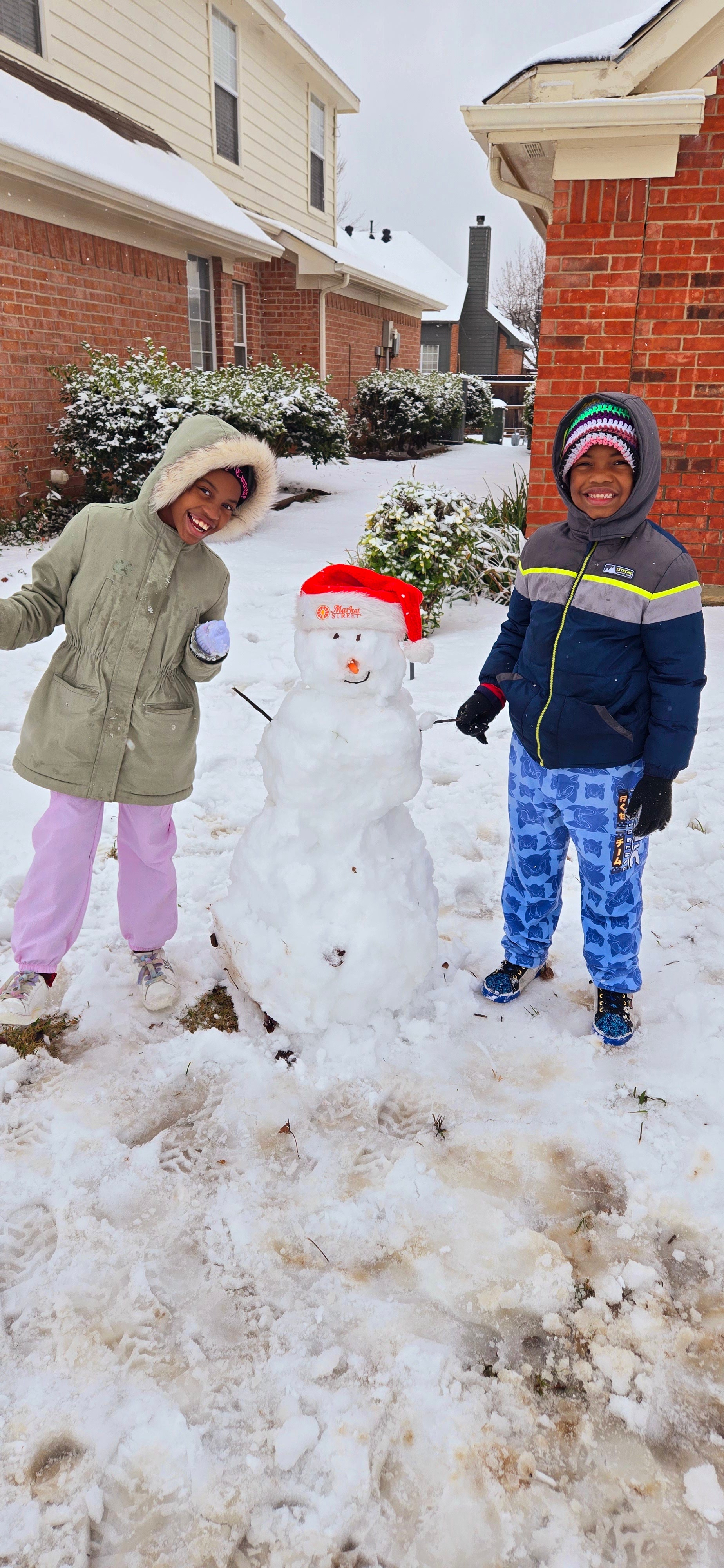 My kiddos in Plano with their Market Street snow man!