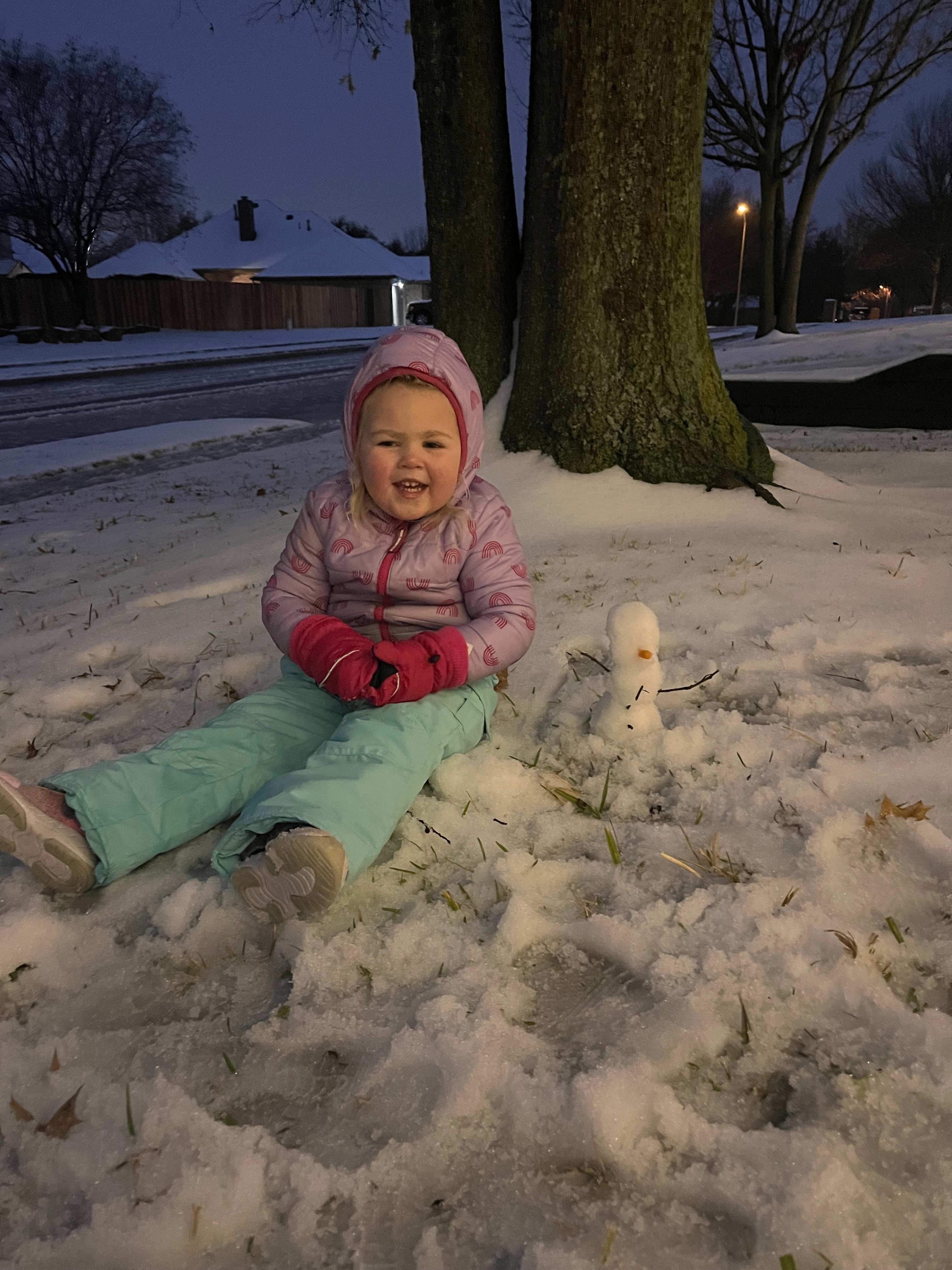 Julia built her first snowman and she is pretty proud!