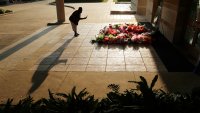 FILE - A woman stops to photograph a memorial for George Floyd