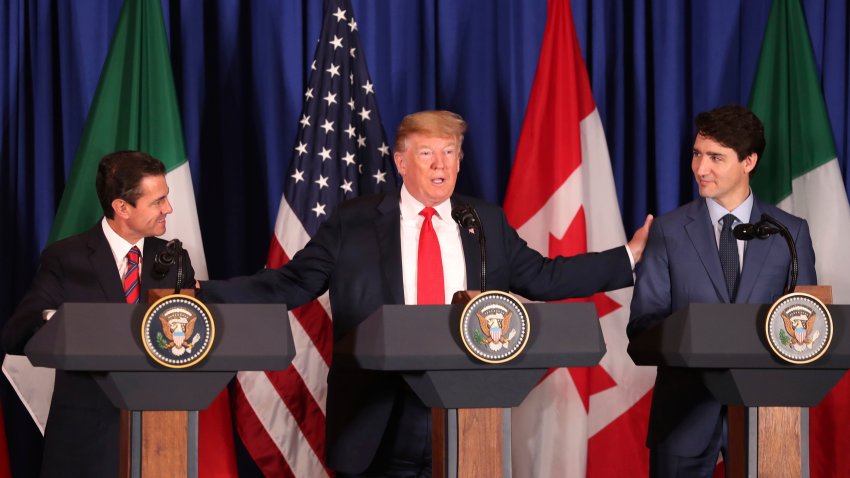 FILE – President Donald Trump, center, reaches out to Mexico’s President Enrique Pena Nieto, left, and Canada’s Prime Minister Justin Trudeau as they prepare to sign a new United States-Mexico-Canada Agreement that is replacing the NAFTA trade deal during a ceremony at a hotel before the start of the G20 summit in Buenos Aires, Argentina, on Nov. 30, 2018.