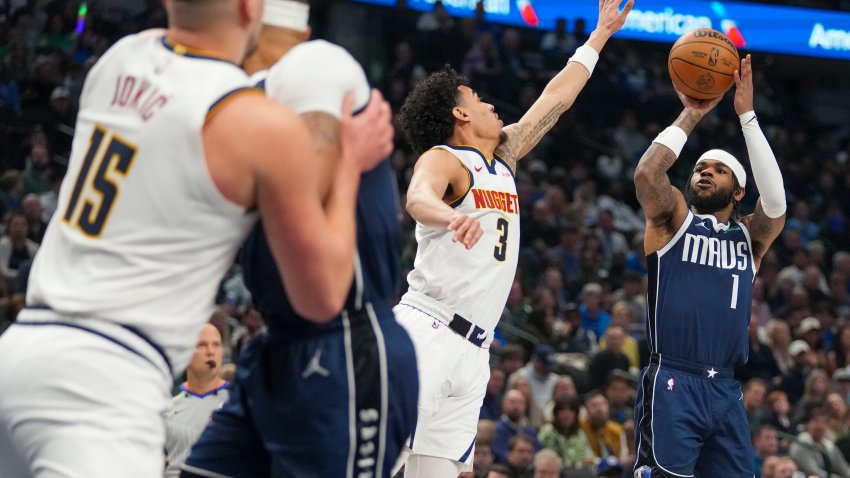 Dallas Mavericks guard Jaden Hardy (1) shoots against Denver Nuggets guard Julian Strawther (3) during the first half of an NBA basketball game, Sunday, Jan. 12, 2025, in Dallas. (AP Photo/Julio Cortez)