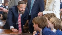 Texas state Rep. Dustin Burrows, R-Lubbock, speaks to his family on the opening day of the 89th Texas Legislative Session in Austin, Texas, Tuesday, Jan. 14, 2025.