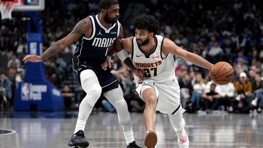 Denver Nuggets guard Jamal Murray (27) works against Dallas Mavericks guard Kyrie Irving (11) in the second half of an NBA basketball game in Dallas, Tuesday, Jan. 14, 2025. (AP Photo/Tony Gutierrez)