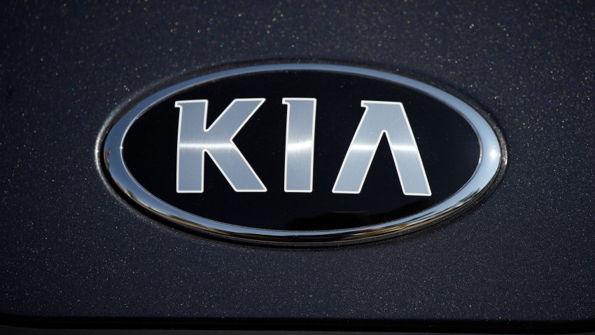 FILE – The company logo shines off the hood of a 2021 K5 sedan on display in the Kia exhibit at the Denver auto show Friday, Sept. 17, 2021, at Elitch’s Gardens in downtown Denver.