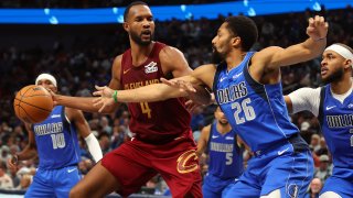 DALLAS, TEXAS – JANUARY 03: Evan Mobley #4 of the Cleveland Cavaliers avoids a steal attempt by Spencer Dinwiddie #26 of the Dallas Mavericks in the second half of an NBA basketball game at American Airlines Center on January 03, 2025 in Dallas, Texas.