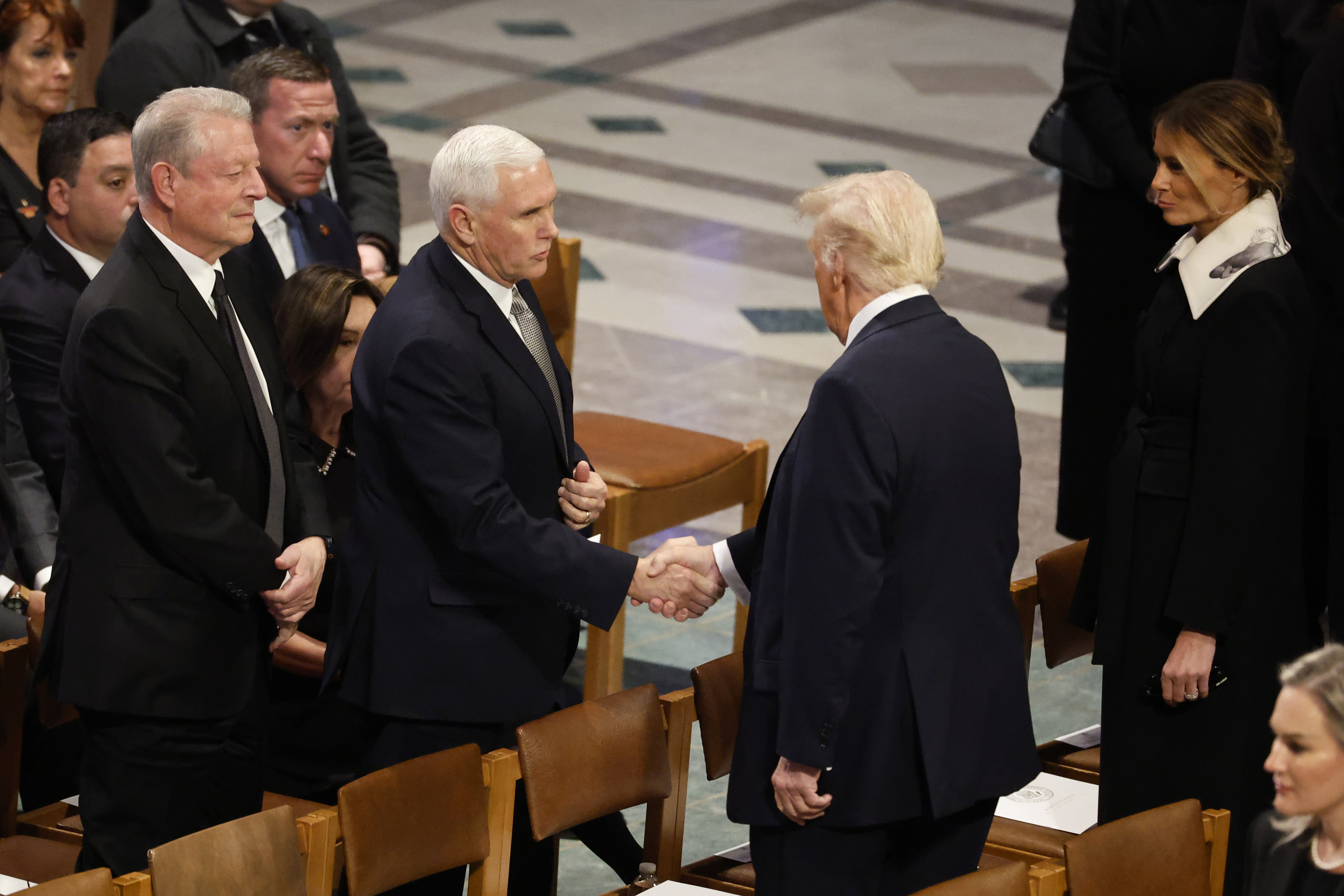 U.S. President-elect Donald Trump greets former U.S. Vice President Mike Pence as he arrives with Melania Trump as former U.S. Vice President Al Gore looks on during the state funeral for former U.S. President Jimmy Carter at Washington National Cathedral on January 09, 2025 in Washington, DC.