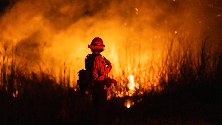 TOPSHOT – A firefighter monitors the spread of the Auto Fire in Oxnard, North West of Los Angeles, California, on January 13, 2025. US officials warned “dangerous and strong” winds were set to push deadly wildfires further through Los Angeles residential areas January 12 as firefighters struggled to make progress against the flames. At least 24 people have been confirmed dead from blazes that have ripped through the city, reducing whole neighborhoods to ashes and leaving thousands without homes. (Photo by ETIENNE LAURENT / AFP) (Photo by ETIENNE LAURENT/AFP via Getty Images)