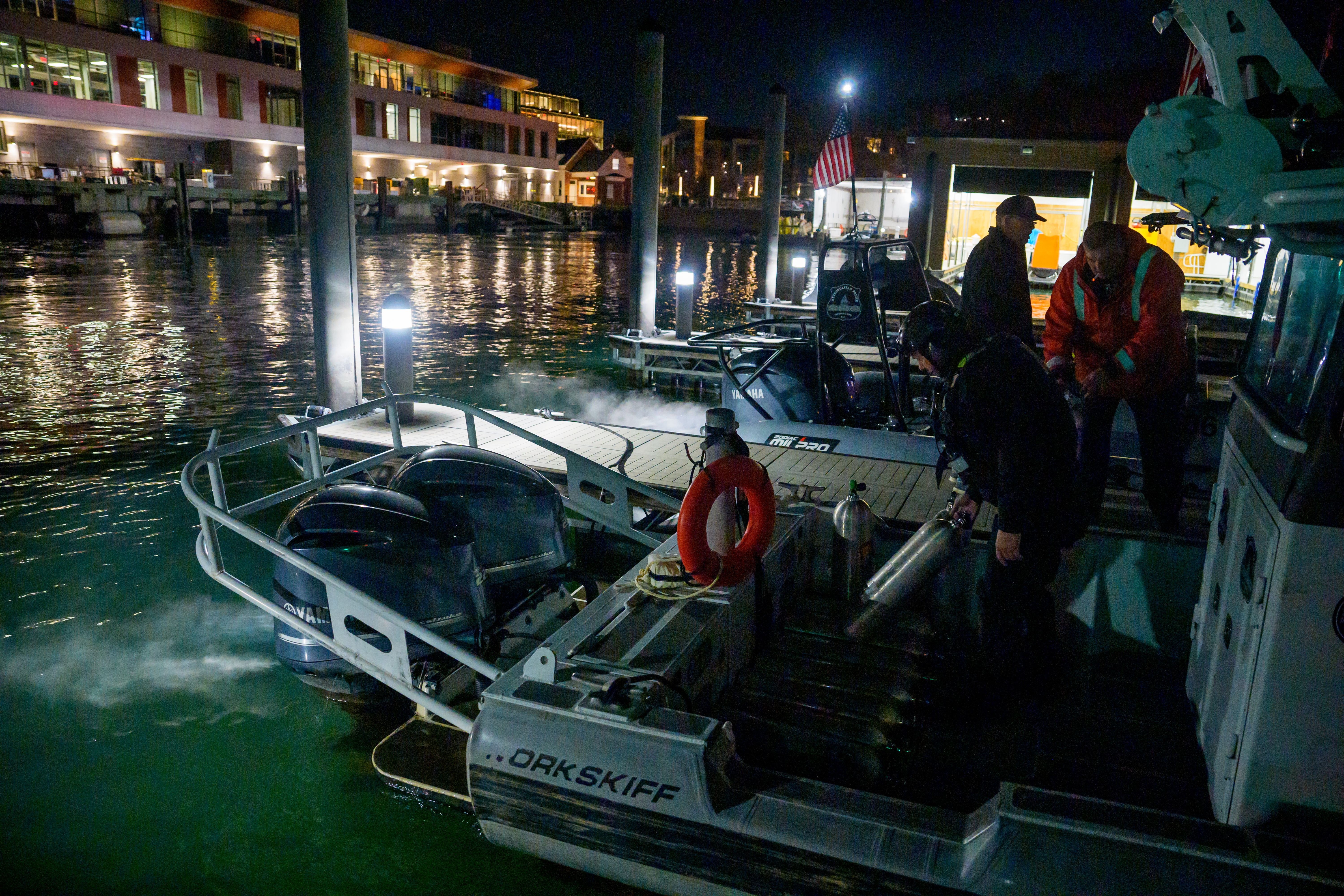 An emergency response team loads diving equipment on a boat to continue working the scene of airplane wreckage in the Potomac River on Jan. 30, 2025.