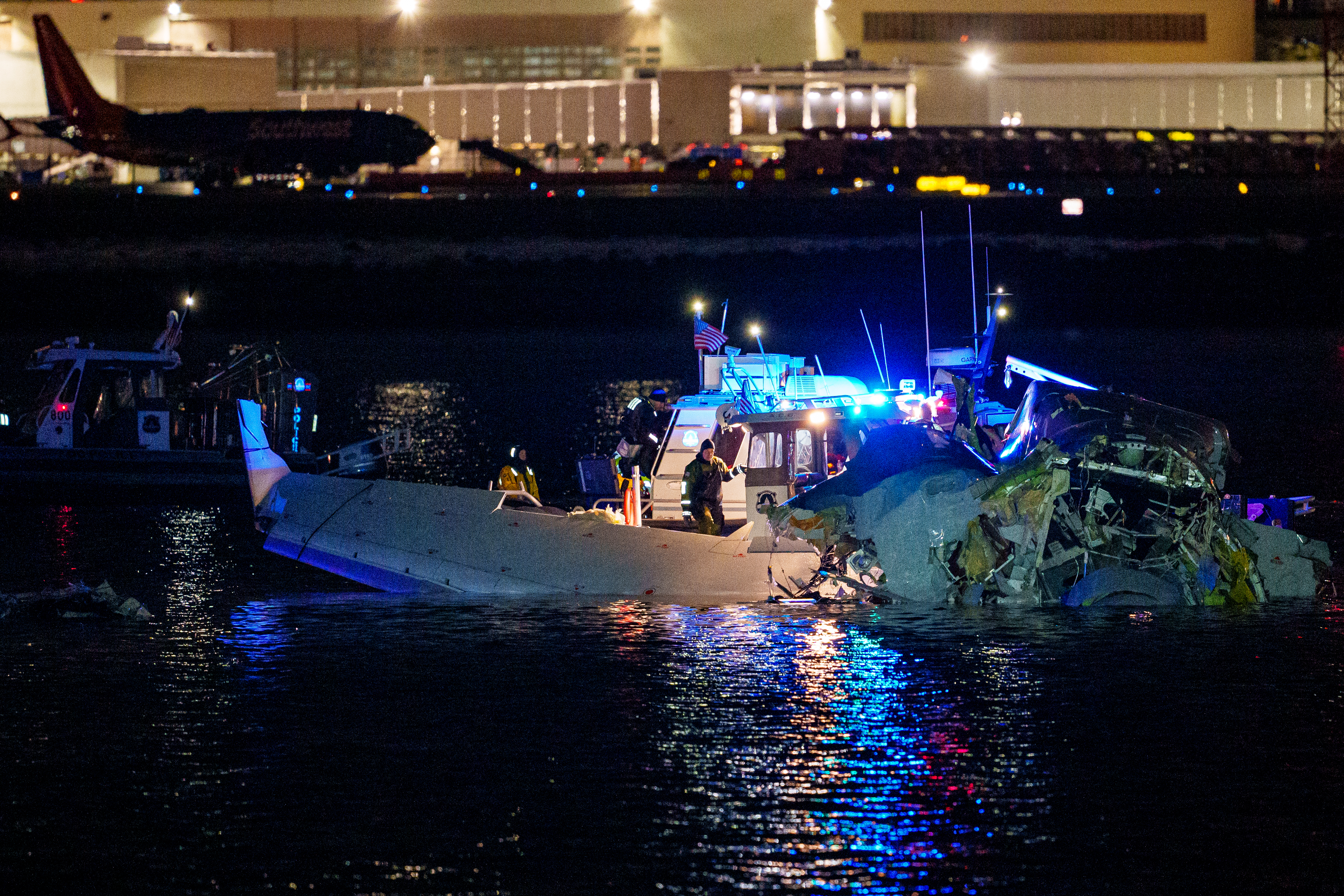 Emergency response units assess airplane wreckage in the Potomac River near Ronald Reagan Washington Airport on Jan. 30, 2025.