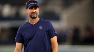 Aug 26, 2023; Arlington, Texas, USA; Dallas Cowboys offensive coordinator Brian Schottenheimer on the field before the game against the Las Vegas Raiders at AT&T Stadium.