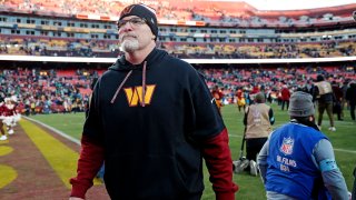 Dec 22, 2024; Landover, Maryland, USA; Washington Commanders head coach Dan Quinn walks off the field after the Washington Commanders beat the Philadelphia Eagles at Northwest Stadium. Mandatory Credit: Peter Casey-Imagn Images