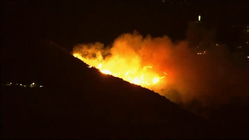 A brush fire burns Wednesday Jan. 8, 2025 in the Hollywood Hills.