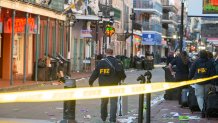 FBI investigators arrive at the scene where the white Ford F-150 pickup truck that crashed into a work lift after allegedly driving into a crowd of New Year's revelers in the French Quarter of New Orleans, Louisiana, on January 1, 2025. At least 10 people were killed and 30 injured Wednesday when a vehicle plowed overnight into a New year's crowd in the heart of the thriving New Orleans tourist district, authorities in the southern US city said. (Photo by Matthew HINTON / AFP) (Photo by MATTHEW HINTON/AFP via Getty Images)
