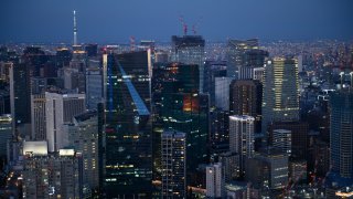 Commercial and residential buildings at dusk in the Minato district of Tokyo, Japan.