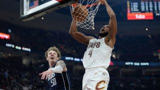 Cleveland Cavaliers forward Evan Mobley (4) dunks in front of Dallas Mavericks center Kylor Kelley (50) in the first half of an NBA basketball game, Sunday, Feb. 2, 2025, in Cleveland. (AP Photo/Sue Ogrocki)