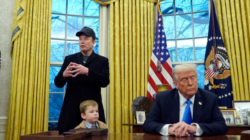 President Donald Trump listens as Elon Musk, joined by his son X Æ A-Xii, speaks in the Oval Office at the White House, Tuesday, Feb. 11, 2025, in Washington.