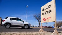 A vehicle drives past a sign outside of Seminole Hospital District offering measles testing Friday, Feb. 21, 2025, in Seminole, Texas. (AP Photo/Julio Cortez)