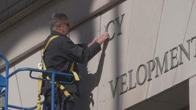 Crews remove USAID letters off of former DC headquarters