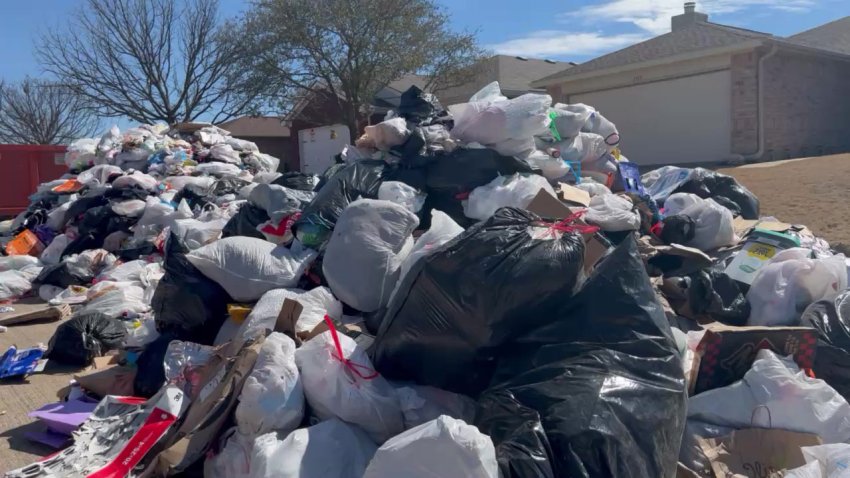 Trash dumped on a street in Anna, Texas, on Thursday, Feb. 20, 2025, after the driver said he saw sparks in the load.