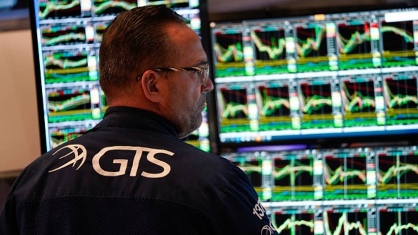 A trader works on the floor of the New York Stock Exchange (NYSE) at the opening bell on March 5, 2025, in New York City. 
