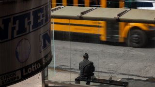 A person waits at a bus stop in the Brooklyn borough on March 25, 2025 in New York City.