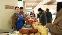 ASTANA, KAZAKHSTAN – JANUARY 26: People purchase sausages and cheese at the agricultural trade market on January 26, 2025 in Astana, Kazakhstan.  