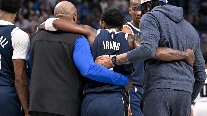 Kyrie Irving helped off the court after injury