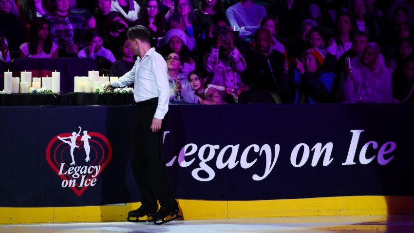 Ilia Kulik places a flower on the memorial during the "Legacy On Ice" U.S. Figure Skating Benefit at Capital One Arena