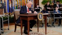 President Donald Trump signs an executive order in the East Room of the White House in Washington, Thursday, March 20, 2025.