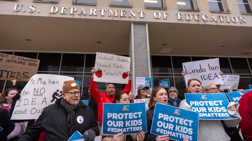 Protestors gather during a demonstration at the headquarters of the Department of Education, Friday, March 14, 2025, in Washington. (AP Photo/Mark Schiefelbein)