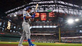 Los Angeles Dodgers’ Tommy Edman walks to the plate to leadoff the first inning of a baseball game against the Texas Rangers Friday, April 18, 2025, in Arlington, Texas. (AP Photo/Julio Cortez)