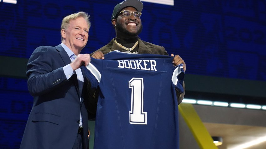 Alabama offensive lineman Tyler Booker, right, poses with NFL Commissioner Roger Goodell after being chosen by the Dallas Cowboys with the 12th overall pick during the first round of the NFL football draft, Thursday, April 24, 2025, in Green Bay, Wis.