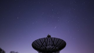 A meteor streaks across the night sky at the InfoAge Space Exploration Center in Wall Township of New Jersey, United States as the Lyrids meteor shower reached its maximum in the early morning of April 22, 2022.