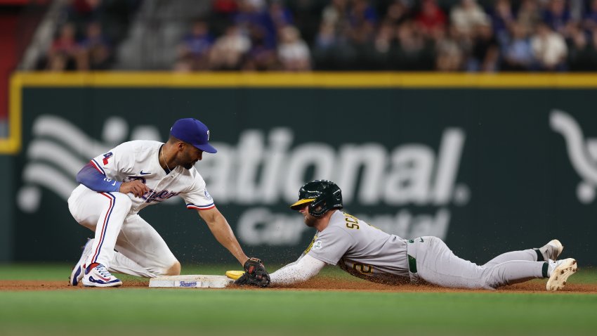 ARLINGTON, TEXAS – APRIL 28: Max Schuemann #12 of the Athletics steals second base ahead of the tag of Marcus Semien #2 of the Texas Rangers during the seventh inning at Globe Life Field on April 28, 2025 in Arlington, Texas.