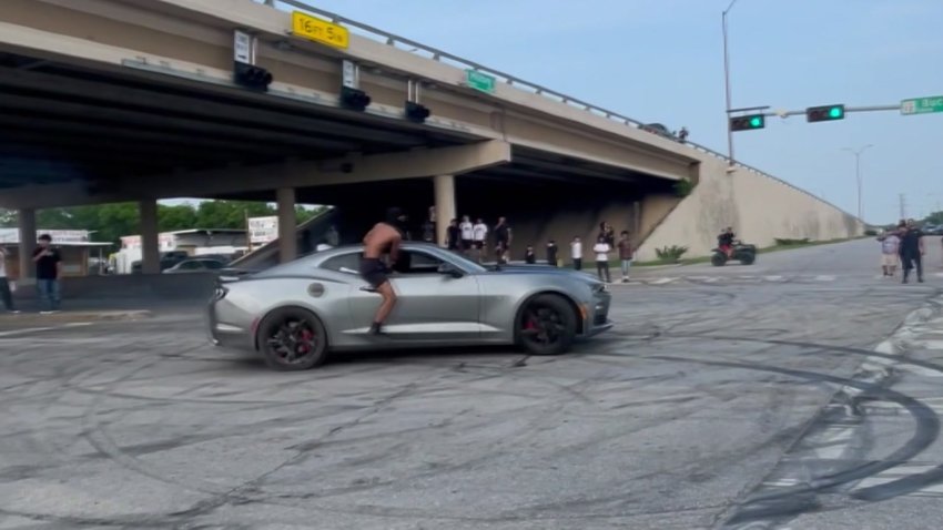A driver drifts and performs donuts at a Dallas intersection.