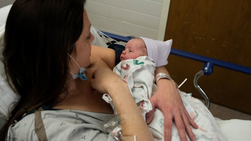 Amanda Dodd holds her newborn child, Madeline, after giving birth in the Family Birth Center at Beaumont Hospital in Royal Oak, Michigan, U.S., February 1, 2022.