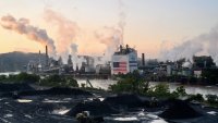 A tugboat pushes a barge near the U.S. Steel Corp. Clairton Coke Works facility in Clairton, Pennsylvania, on Sept. 9, 2024.
