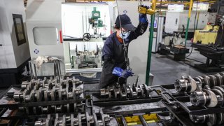 An employee works on a vehicle crankshaft production line at a factory which produces engine parts in Binzhou, in eastern China’s Shandong province on March 14, 2025.