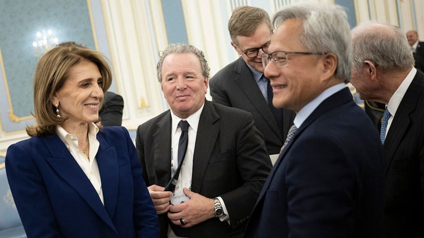 Alphabet Chief Investment Officer Ruth Porat (L) and Nvidia CEO Jensen Huang (R) wait to meet the Saudi Crown Prince at the Royal Court in Riyadh on May 13, 2025.