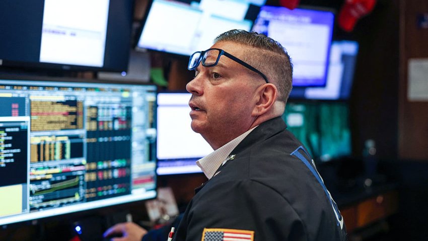 A trader works on the floor of the New York Stock Exchange (NYSE) at the opening bell on May 19, 2025, in New York City.