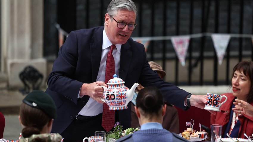 UK Prime Minister Keir Starmer and his wife Victoria Starmer serve tea and cake in Downing Street on May 5, 2025 in London, England.