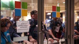 Security officers block entrance doors after pro-Palestinian protesters attempted to enter the Microsoft Build conference at the Seattle Convention Center Arch building in Seattle, Washington on May 19, 2025.
