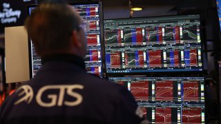 Traders work on the floor of the New York Stock Exchange (NYSE) at the opening bell on May 27, 2025, in New York City.