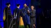 University of Buffalo grad chased by police as he runs across stage holding his baby