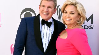 FILE – Todd Chrisley, left, and his wife, Julie Chrisley, pose for photos at the 52nd annual Academy of Country Music Awards on April 2, 2017, in Las Vegas.