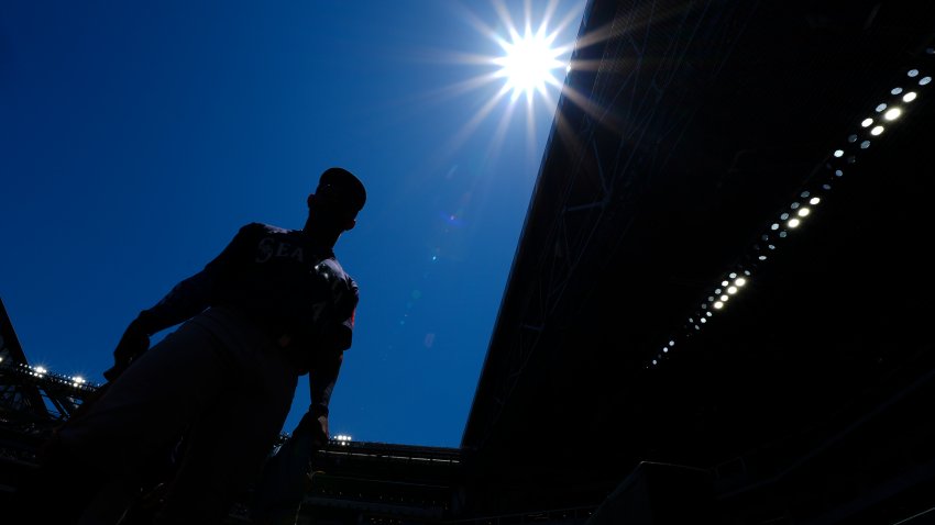 Seattle Mariners outfielder Julio Rodríguez heads to the dugout after warming up prior to a baseball game against the Texas Rangers Sunday, May 4, 2025, in Arlington, Texas. (AP Photo/Julio Cortez)
